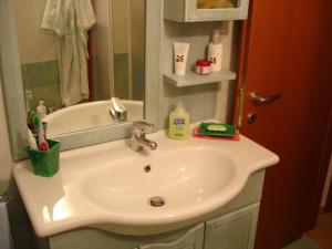 a bathroom with a white sink and a mirror at Sardinia Sea Vacation Villa in Costa Paradiso +43 photos