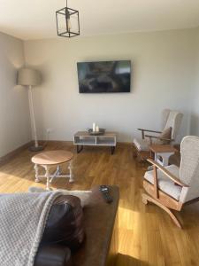 a living room with a couch and chairs and a table at Cruit Island Holiday Rent in Cruit