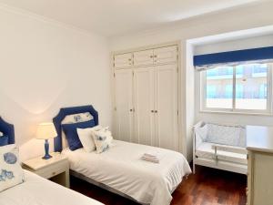 sypialnia z 2 łóżkami i oknem w obiekcie Vilamoura Central 2 Bedroom Apartment w mieście Vilamoura
