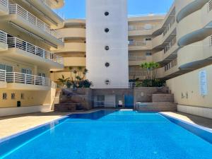a swimming pool in the courtyard of a building at Vilamoura Central 2 Bedroom Apartment in Vilamoura