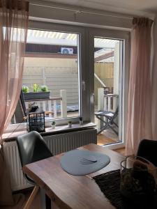 a dining room with a table and a large window at Ferienwohnung „kleine Auszeit“ in Walkenried +19 photos