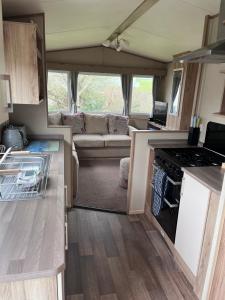an interior view of an rv kitchen and living room at Newquay Caravan, Newquay Bay Resort Jetts View 104 in Newquay
