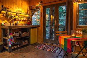 a kitchen with a table with a colorful table cloth at Sambliku Treehouse in Jõgisoo