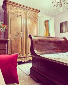 a bedroom with a large wooden bed and a red pillow at Art action room 