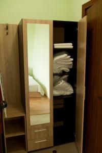 a wardrobe with a mirror in a room at Alfa Guest House - Free Parking in Varna City