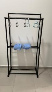 a glass rack with three blue towels and lights at Sandakan Homestay Apartment Forest Cabin 森林小屋 2R2B in Sandakan