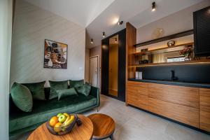 a living room with a green couch and a table at Enyana Luxury Suites in Kotor