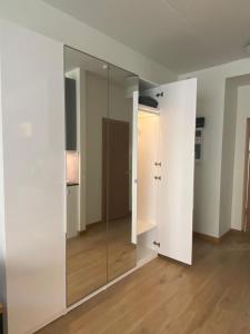 a glass door in a room with a hallway at Pearl - new and cosy apartment close to Center in Rīga