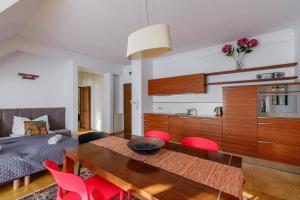 a living room with a dining table and a kitchen at Golden Apartments Zakopane&S3 in Zakopane