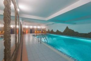 a large swimming pool in a building with a large swimming pool at Golden Apartments Zakopane&S3 in Zakopane