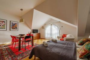 a bedroom with a bed and a table and chairs at Golden Apartments Zakopane&S3 in Zakopane