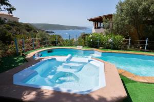 a large swimming pool with a swimming pool at Hotel Villa Belfiori in Torre Dei Corsari