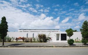 a white building on the side of a street at Villa Conte in Miyako Island