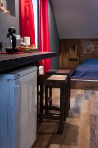 a kitchen with a counter and a bed in a room at Гостьовий дім Білий Пацюк in Kamianets-Podilskyi