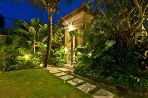 a house with a garden at night with lights at Villa Mango - 3 Bedroom Villa in Seminyak in Seminyak