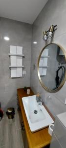 a bathroom with a white sink and a mirror at Yellow apartman in Vrnjačka Banja