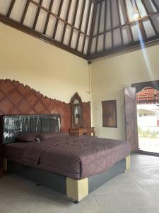 Кровать или кровати в номере Mangku Homestay