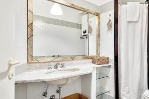 a white bathroom with a sink and a mirror at La Finestra sul Borgo, Terre Marine in Corniglia