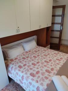 a bedroom with a bed with a floral bedspread at Apartments for you in Matera