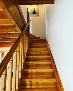 a staircase in a house with wooden floors at Perdika's Nest, family friendly house by the sea in Perdika