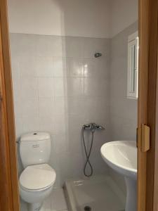 a bathroom with a toilet and a sink at Perdika's Nest, family friendly house by the sea in Perdika