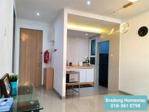 a kitchen with a counter and a table in a room at BRADONG HOMESTAY - MUSLlM ONLY, 3 Queen Bedrooms, Seaview, Infinity Pool, Gym, near Drawbridge & KTCC Mall in Kuala Terengganu