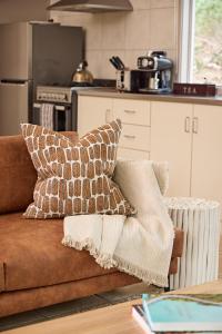 a couch with two pillows on it in a kitchen at Aquila Eco Lodges in Dunkeld