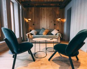 a living room with two chairs and a couch at Hotel MONT-BLANC VAL D'ISERE in Val dʼIsère