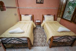 Cama o camas de una habitación en Hôtel Faouzi