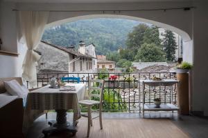 a view from a balcony with a table and chairs at bb chiavenna centro storico in Chiavenna