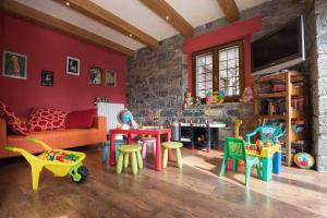 a living room filled with lots of colorful furniture at Locanda Romana in Fanano