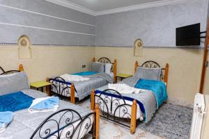 Cama o camas de una habitación en Hôtel Faouzi