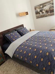 1 dormitorio con cama con edredón y almohadas en Le Loft Vintage Epernay avec Netflix, Vélos, Parking gratuit, en Épernay