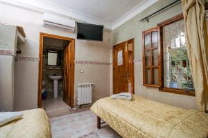 Cama o camas de una habitación en Hôtel Faouzi