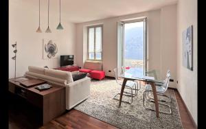 a living room with a couch and a table at Larius Apartment Carate Urio in Laglio