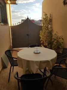 a white table and chairs on a balcony with a table and chairs at The Quiet Corner in Kalamata