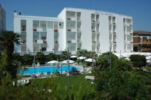 a large white building with a swimming pool in front of it at Hotel Parco Delle Rose in Silvi Marina