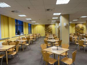 an empty dining room with tables and chairs at A&S Ferienzentrum Oberhof in Oberhof