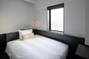 Postel nebo postele na pokoji v ubytování DDD HOTEL