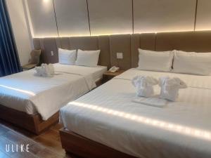 Postel nebo postele na pokoji v ubytování HO TRAM GOLDEN HOTEL