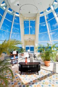a lobby with large windows and a black table at Oyster Bay Beach Resort in Dawn Beach