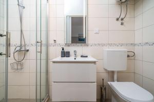 a bathroom with a toilet and a sink and a shower at Studio Apartman LEMON in Dubrovnik