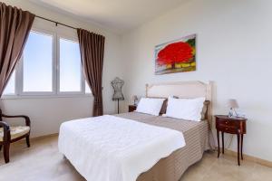 a bedroom with a white bed and a window at Sea side apartment between Nice and Monaco - 2 in Villefranche-sur-Mer