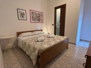 a bedroom with a bed with two pillows on it at Casa Colombo in Sperlonga +19 photos