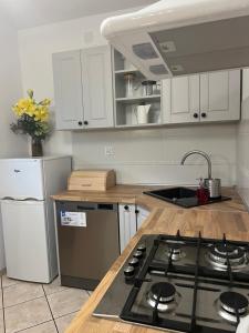 a kitchen with white cabinets and a stove top oven at Dom na Lawendowej in Głuszyca