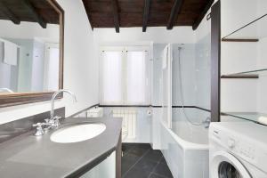 a bathroom with a sink and a washing machine at Il Borgo dei Ricordi, Terre Marine in Corniglia