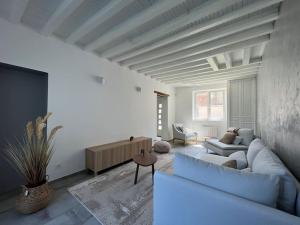 a living room with a blue couch and a tv at Cosy &Jolie Maison tout à coté de DisneyLand Paris in Montry