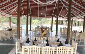 una zona de comedor con mesas y sillas en un pabellón en Tuli Veer Bagh Resort en Nagpur