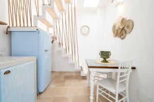 a kitchen with a small table and a staircase at Apulia Charming Suites - Casa Lonfo Suite Sole in Monopoli