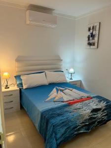 a bedroom with a bed with a surfboard on it at Bungalow Isla Margarita in Puerto Rico de Gran Canaria